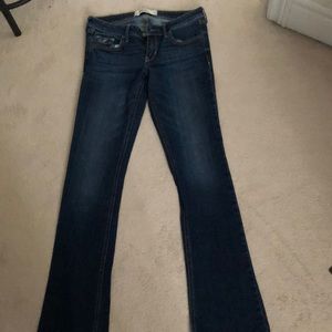 Darker blue Jean with faint fading in front to made look worn